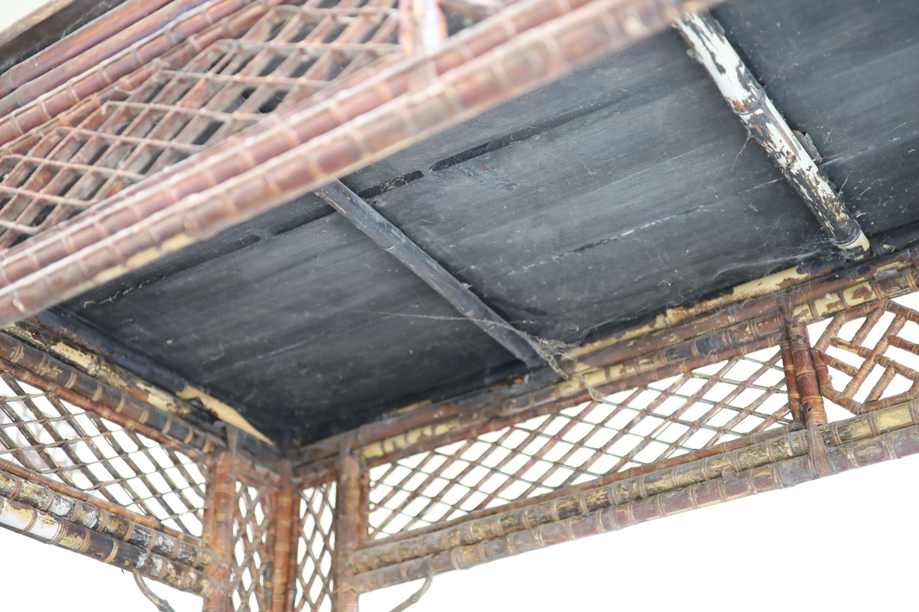 A bamboo and rattan centre table, with black lacquered top, width 166cm depth 76cm height 86cm